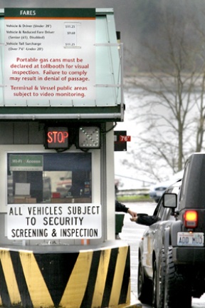 Passengers line up their vehicles at the Bainbridge Island Ferry Terminal Thursday afternoon. A fare boost may be on the horizon.