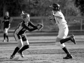 Brittany Wisner tags out North Kitsap’s Josie Ball before Ball makes it to second in earlier season play. The Spartans are 7-1 in Metro League play
