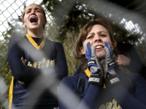 Brittany Wisner (left) and Stephanie Wagner cheer for Kelcee Azure as she made it to first base at Friday’s game against Sequim. The Spartans lost to the Wolves 8-1. It's only their second loss at home.