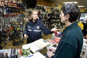 Fire Inspector Cindy Klugiewicz (left) discusses her annual safety assessment of Winslow business B.I.Cycle with its owner Tom Clune (right) Thursday afternoon.