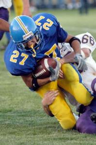 Running back Derek Houston is brought down by Viking defensive linebacker Chuck Dryden in Friday night’s loss at Memorial Stadium.