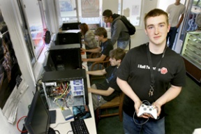 Josh Philips stands amid video game players busily blasting intergalactic baddies in the 17-year-old’s new sports cards