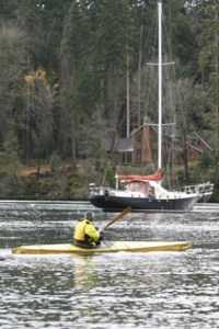 A kayaker splits Blakely Harbor’s calm waters.