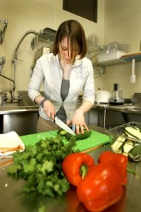 Island Health Foods prep chef Kayleigh O'Hara slices vegetables in the store's cafe. In addition to serving food on-site