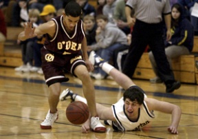 Spartan Theo Miller and O’Dea’s Kelly Edwards try to get control of a loose ball.
