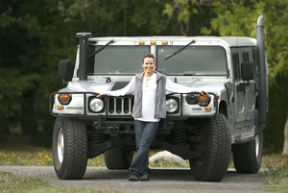 Tonya Croman poses with her biodiesel-fueled Hummer. The 4-ton vehicle runs cleaner than a typical gas-powered coupe.