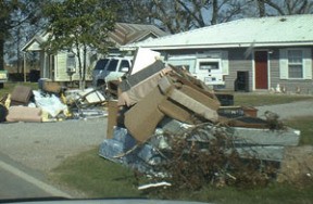 Debris from once-flooded homes sits at curbside in Vermilion Parish