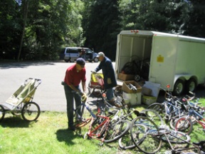 (L-R) Kiwanians Hank Keaton and Bob Gedney load up bikes leftover from last summer’s Rotary Auction to recycle into new bikes.