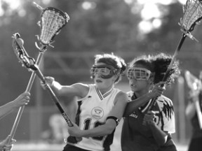 Freshman Sally Baumgartner takes control of the ball from Holy Names.