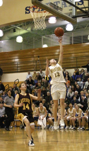 Emily Farrar punctuates a fast break with a layup during fourth-quarter play in the Spartans’ 53-25 win over Lakeside at Paski Gym Wednesday. Next up: Prep.
