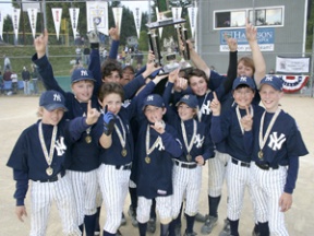 The Yankees celebrate with the trophy after their 3-2 win over the Pirates in the Bainbridge Island Little League Majors championship.