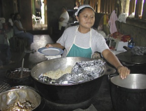 Aryeris Flores dishes up black beans and rice for hungry travelers to Finca Magdalena on the island of Ometepe.