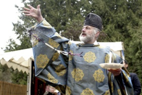 Shinto priest Koichi Barrish blesses the land at the former Eagledale dock where Japanese-Americans departed for wartime internment camps in 1942.