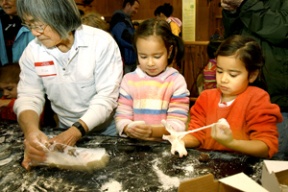 Hisa Matsudaira (left) helps mochi makers Hana Anderson