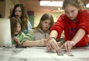 Ali Davis (right) navigates a simulated sub with crew Maddy Devlin (second from right)