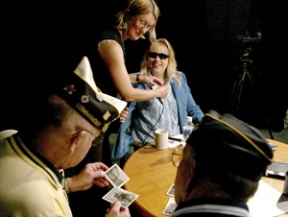 P.J. Scott (center) smiles as a crew member affixes a microphone to her collar prior to a taping of Veterans Forum last week.