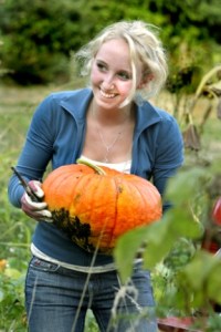 Devin Groman ventures into the pumpkin patch behind Bay Hay and Feed to retrieve a hefty orange fruit for Sunday’s fund-raiser.