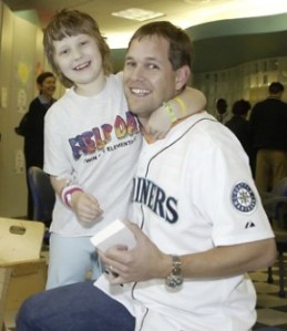 Seattle Mariners pitcher Aaron Sele receives a hug from Brianna Marble