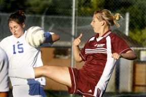 Defender Kathryn Deveraux battles with a Holy Names player for the ball. The Spartans lost their first Metro League Mountain Division game of the season to the Cougars 4-3 on Tuesday.