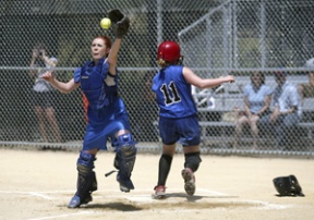 East Jefferson catcher Sarah Bacchus tries to tag Bainbridge’s Hailey Willmann as she crosses home plate at Sunday’s championship game at Strawberry Field