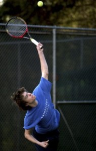Junior Taylor Lea serves at practice.