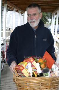 Charlie Kidd collects Thanksgiving baskets at Helpline Monday morning.