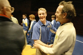 Bainbridge wrestling coach Dan Pippinger shares a laugh with the Bishop Blanchet coaches after their match Tuesday night. The former Bainbridge High School alum