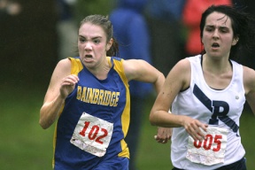 Emily Farrar (left) runs past Seattle Prep’s Kate Bradford at Thursday’s Metro League meet in Seattle. The junior finished in seventh place with a time of 20:19. The girls finished in fifth.