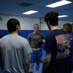 Luciano Marano | Bainbridge Island Review                                Spartan Head Coach Dan Pippinger talks with the varsity wrestling team prior to the start of practice last week.