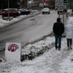 Luciano Marano | Bainbridge Island Review                                One stalwart couple brave the chill and the quickly-melting snow Friday morning for a walk downtown.