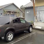 Woman drives into building