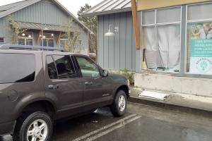 Woman drives into building