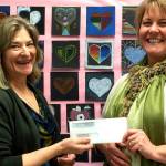 Photo courtesy of Bainbridge Arts & Crafts | Bainbridge Arts & Crafts Executive Director Lindsay Masters presents Sonoji Sakai Intermediate School art teacher Maggie Hitchcock with a check earlier this month as part of an annual donation effort by BAC to local elementary, middle, and high schools to supplement their art supply budgets and support visual art programming.