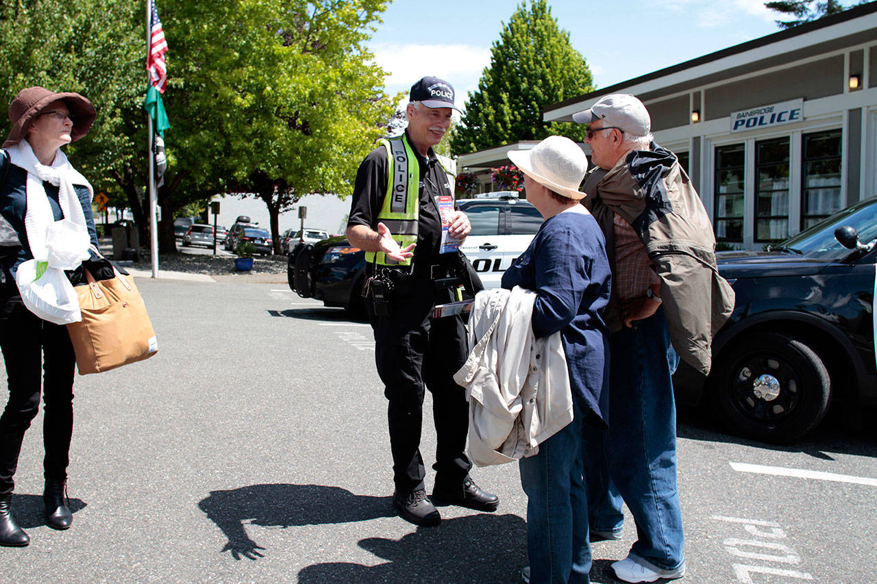 Luciano Marano | Bainbridge Island Review &mdash; Bainbridge Island Police Departmetn Parking Enforcement Officer Ken Lundgren assists some lost tourists. Lundgren was one of two key speakers at the last Citizen&rsquo;s Police Academy class.