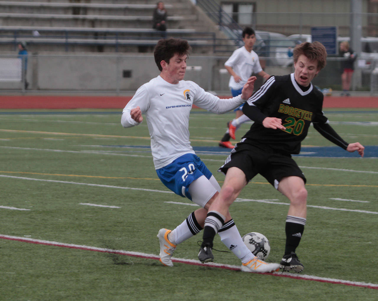 Luciano Marano | Bainbridge Island Review &mdash; BHS junior Jacob Keasler collides with a Roosevelt player during a home match Tuesday. The Spartans were bested 2-1, their first loss of the year.