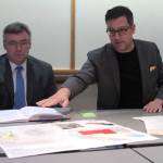 Luciano Marano | Bainbridge Island Review &mdash; Bainbridge Island City Manager Doug Schulze and Matthew Coates, president of Coates Design, unveil comparison charts of the three sites found to be the most preferable to serve as the location of the new police station.