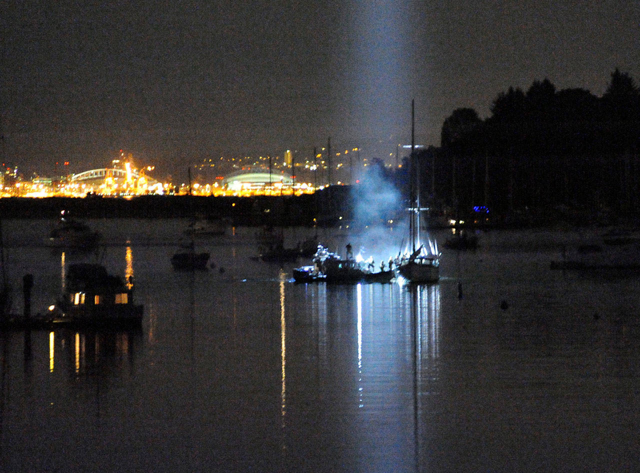 Police swarm aboard the Flying Gull in Eagle Harbor after shooting the gunman aboard the sailboat. Dinah Satterwhite photo