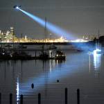 King County Sheriff&rsquo;s Department Guardian One helicopter shines a light on the sailboat Flying Gull after a gunman aboard the vessel began shooting at the shoreline along Eagle Harbor on Saturday, July 8. Diane Satterwhite photo