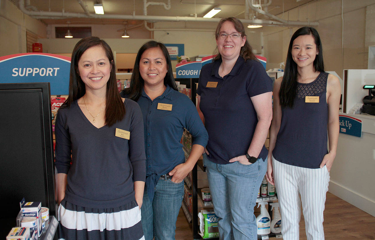 Luciano Marano | Bainbridge Island Review - KC Tan (at left), owner of Bainbridge Island Community Pharmacy, stands with her staff on the new Winslow shop&rsquo;s opening day.