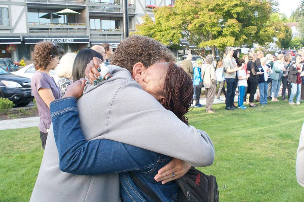 Nick Twietmeyer | The Bainbridge Island Review Kevin Bernstein hugs Brenda Fantroi-Johnson after she stepped forward to speak during the vigil.