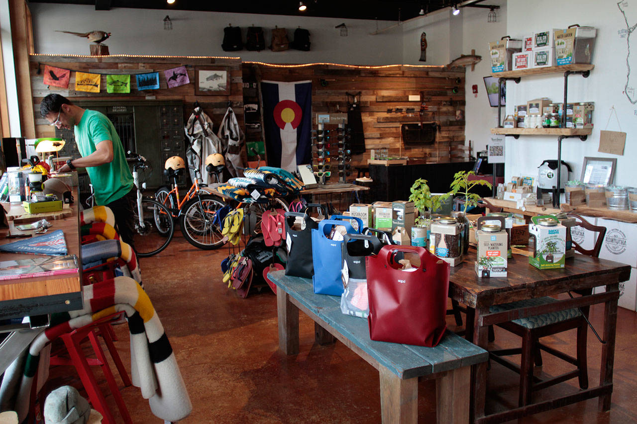 Luciano Marano | Bainbridge Island Review - Matt Otepka arranges the wares in his Lynwood shop Bainbridge Island Outfitters + Depot.