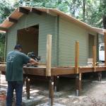 Nick Twietmeyer | The Bainbridge Island Review                                Casey Shortbull works to build the deck of one of the new cabins at Fay Bainbridge Park.