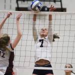 The Spartans&rsquo; Erica Sprott elevates for a block against HNA. (Brian Kelly | Bainbridge Island Review)
