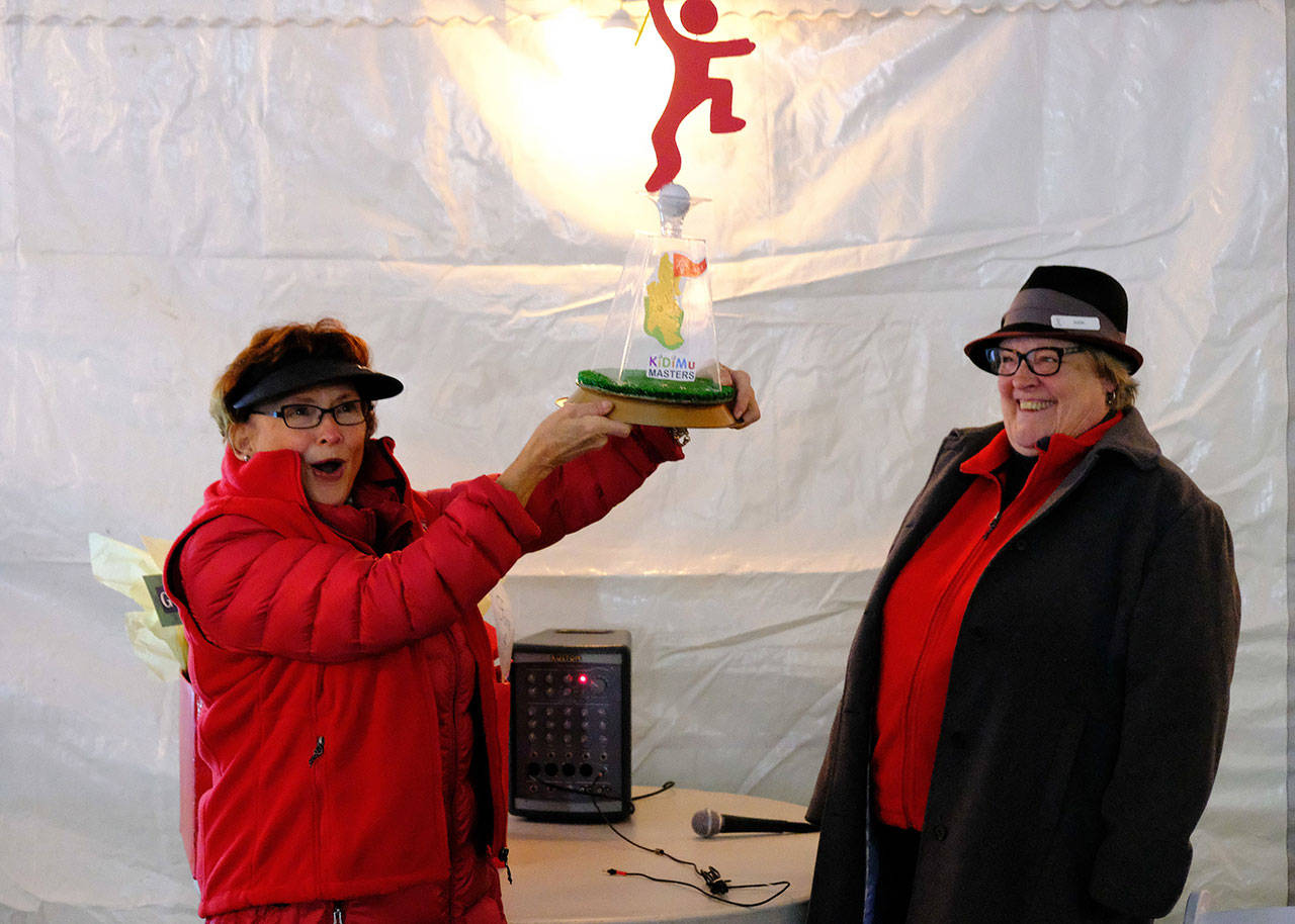 Lauren Murphy hoists her trophy for KiDiMu Masters Champion at the close of the fundraising event.