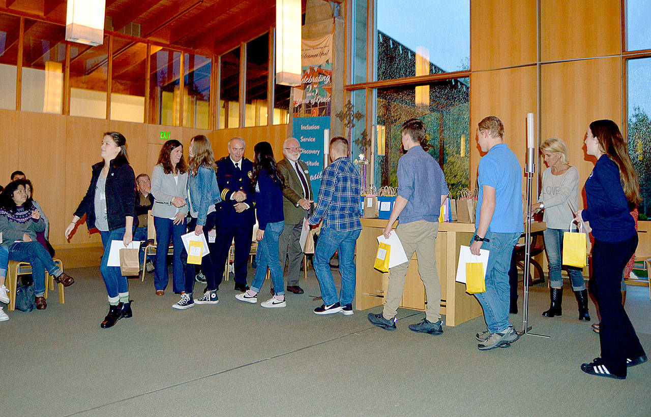 Mayor Val Tollefson, Police Chief Matthew Hamner and BHS Principal Kristen Haizlip congratulate students during the Nov. 19 Bainbridge Youth Services Compassionate Action Awards ceremony at Grace Episcopal Church. (Demi Allen photo)