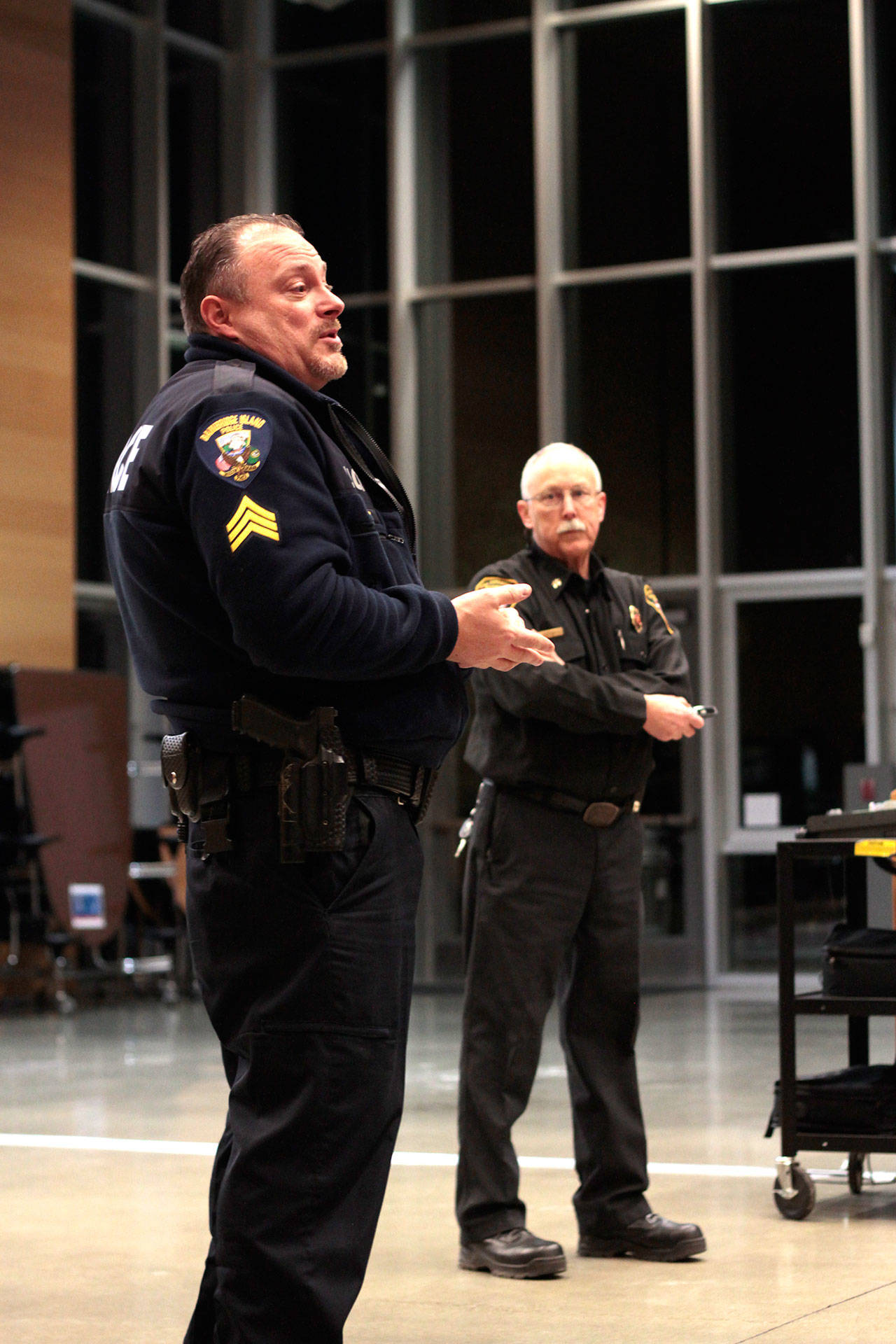 Luciano Marano | Bainbridge Island Review - Before a crowd of about 35 people, Bainbridge Island Police Department representative Sgt. Trevor Ziemba and Assistant Chief Luke Carpenter, of the Bainbridge Island Fire Department, discussed and shared an abbreviated version of the training they would be giving to island students in Grades 9-12 later in the week, What to Do in Lockdown & Active Shooter Situations: Emergency Responders Share Best Practices, Tuesday night in the Bainbridge High School Commons.