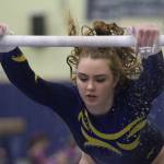 Remi Rosencrans starts her bar routine during last weeks home gymnastics meet. (Brian Kelly | Bainbridge Island Review)