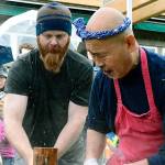 Jason Canfield pounds the mochi with a mallet at the instruction of mochi master Shoichio Sugiyama. (Mark Krulish/Kitsap News Group)