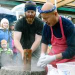 Jason Canfield pounds the mochi with a mallet at the instruction of mochi master Shoichio Sugiyama. (Mark Krulish/Kitsap News Group)
