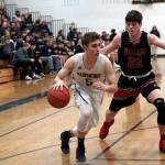 Luciano Marano | Bainbridge Island Review - Spartan sophomore Jonathan Kussie moves around a Ballard defender on his way to the hoop in Fridays home game.